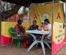 A mother consults with health workers in Tanzania.